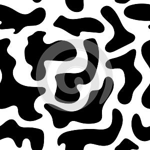 Seamless abstract cow pattern. Simple vector texture - white background with black shapeless spots, dalmatian print