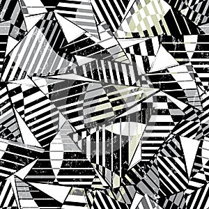 Seamless abstract geometric background pattern, with triangles, lines, paint strokes and splashes, black and white