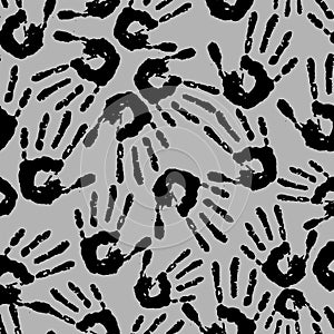seamless abstract pattern of black handprints on a gray background