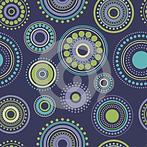 Seamless abstract pattern green, yellow and turquoise circles and dots on dark blue. Kaleidoscope background