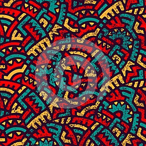 Seamless african pattern. Ethnic and tribal motifs. Orange, red, yellow, blue and black colors. Grunge texture. Vintage print for