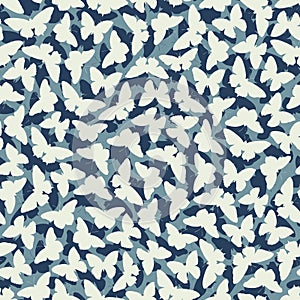 Seamless blue background with moths butterflies.