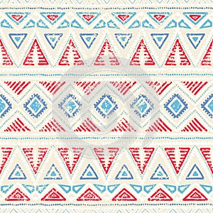 Seamless ethnic pattern. Ornament in tribal style. Grunge texture. Vintage print. Red, white and blue geometric elements.