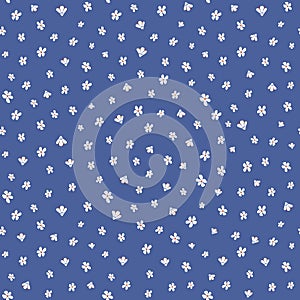 Seamless floral pattern with white flowers scattered random on blue background