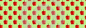 Seamless food pattern. Red sweet bell pepper on a green background. Organic vegetable, healthy ingredient