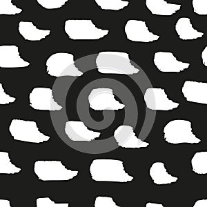 Seamless grunge style brush strokes and ink spots in a monochrome vector pattern