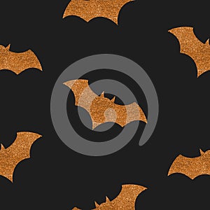 Seamless Halloween pattern with golden glitter bat silhouettes on black background