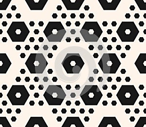 Seamless hexagonal background with different sized hexagons.
