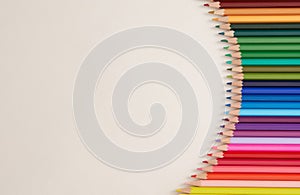 Seamless horizontal pattern Colored pencils arranged in a wave with copy space for note, text, on white background top view