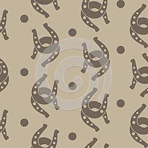 Seamless horseshoes pattern with brown background