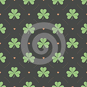 Seamless irish green pattern with clover and heart on a dark gray background