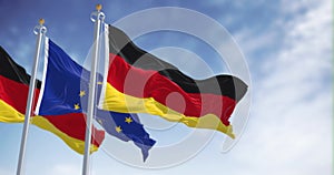 Seamless loop in slow motion of Germany and the European Union flags waving