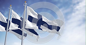 Seamless loop in slow motion of three Finland national flags waving