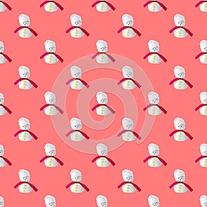 Seamless looping pattern with snowmans with a red scarf isolated on a pink background. concept of handiwork and crafts for the new