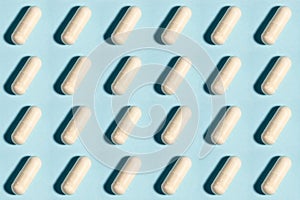 Seamless medical pill, pharmaceutical medicine capsule pattern. Painkiller, vitamin, antibiotic, probiotic on blue background