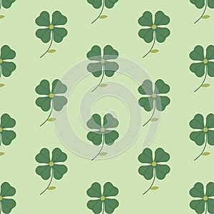 The seamless pattern with the abstract clover on the green background