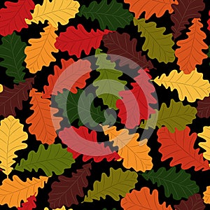 Seamless pattern. Autumn. Multicolored fallen oak leaves on a black background. Flat style.