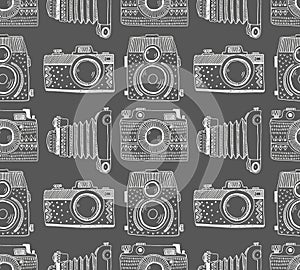 Seamless pattern background with hand drawn ornamental retro cameras.