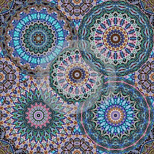 Seamless pattern with beautiful mandalas in emerald, sapphire, crimson and brown colors. Print for fabric, bedding, curtain