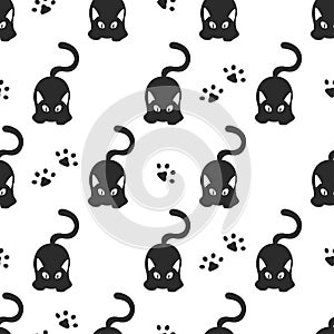 Seamless pattern with black cats and cat paws