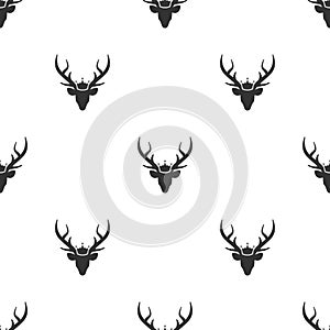 Seamless pattern with black silhouette of deer head with royal crown