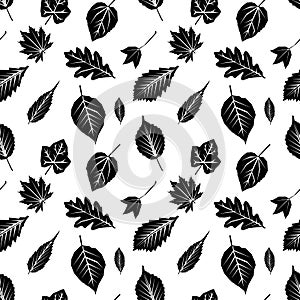 Seamless pattern with black silhouettes of autumn leaves on white. Flat design Vector