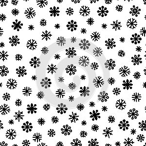 Seamless pattern of black snowflakes on a white background. Simple pattern for backdrops, wrapping paper and seasonal