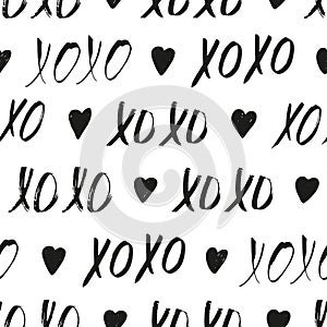 Seamless pattern with black XOXO phrases and hearts