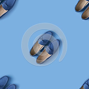 Seamless pattern of blue suede man`s mocassin shoes over blue background