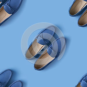 Seamless pattern of blue suede man`s mocassin shoes over blue background