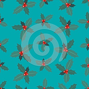 Seamless pattern of branches of Christmas holly with berries on a blue background.