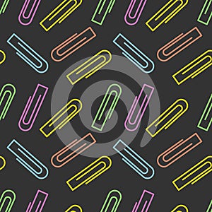 Seamless pattern of bright colorful paper clips on a dark background. Office and school stationery