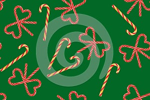 Seamless pattern of Christmas candies on a green background