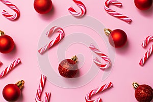 Seamless pattern from christmas candy canes and red balls, festive design paper