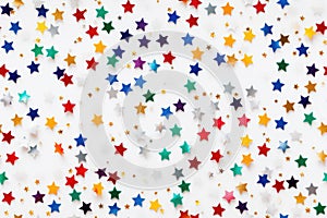 Seamless pattern of colored stars confetti on white background. Flat lay, top view