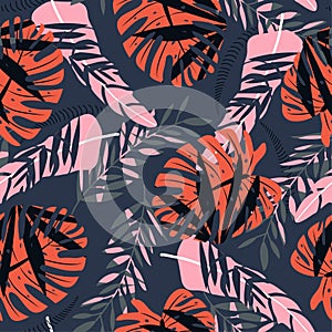 Seamless pattern with colorful tropical plants on dark background. Vector design. Jungle print. Floral background.