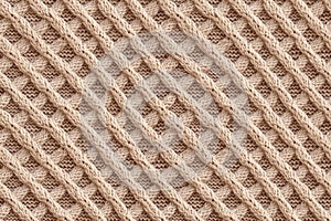 Seamless pattern of a cozy beige knitted wool plaid