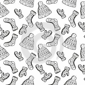 Seamless pattern with cute warm cozy knitted hat, glowes and sockes with winter ornament. Vector hand drawn sketch illustration in