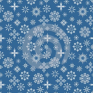 Seamless pattern. Different white snowflakes on a deep blue background. Winter texture for print, wallpaper, home decor, textile