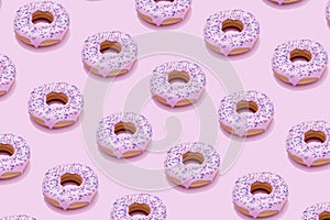 Seamless pattern with donuts with pink glaze on pink background