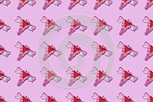 Seamless pattern of female reproductive system, uterus, ovaries, pink background