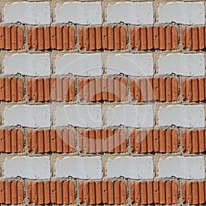 Seamless pattern of fragment of red and white stone wall