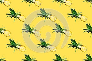 Seamless pattern of fresh pineapple halves isolated on yellow background.Top view