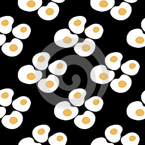 Seamless pattern with fried eggs. Sunny side up eggs pattern on black background. Healthy breakfast pattern for wrapping photo
