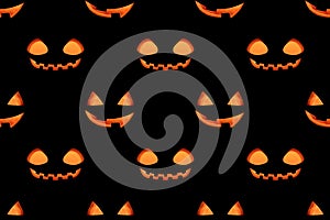 Seamless pattern with a glowing jack lantern smile on a black background. Jack o lantern pumpkin head background