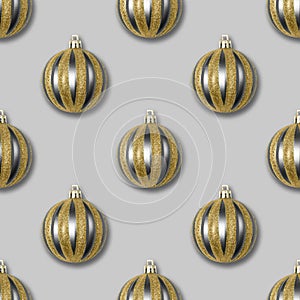 Seamless pattern with gold and silver Christmas balls on a grey background