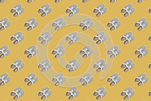 Seamless pattern of grey classic sneakers on yellow background