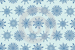 Seamless pattern with hand drawn blue snowflake icons. Winter Christmas festive background, snow texture backdrop