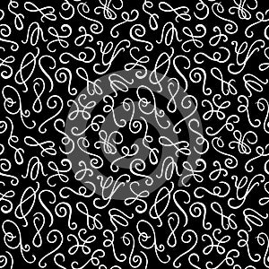 Seamless pattern. Hand drawn curls on the black background.