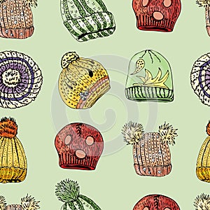 Seamless pattern with hand drawn knitted hats and berets. Colored elements on green background
